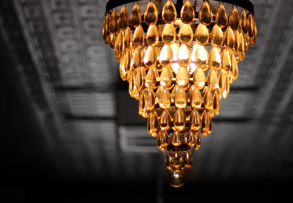 Luxury amber crystal teardrop chandelier hanging from a ceiling