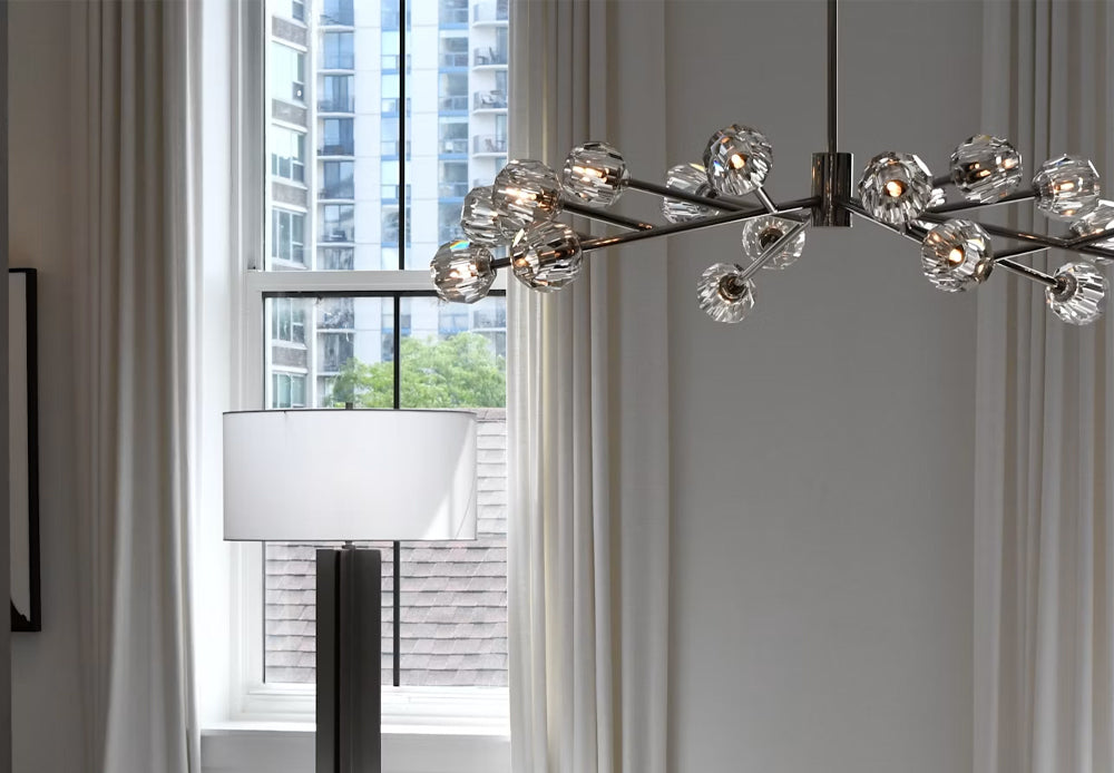 Modern luxury crystal chandelier and floor lamp in a bright room with white curtains