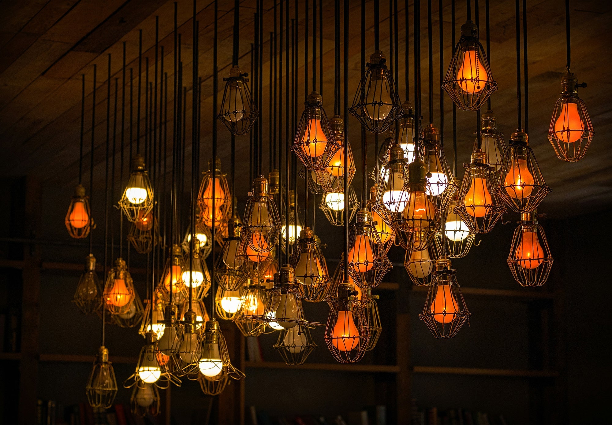 Luxury industrial hanging lights with Edison bulbs and metal cage shades.